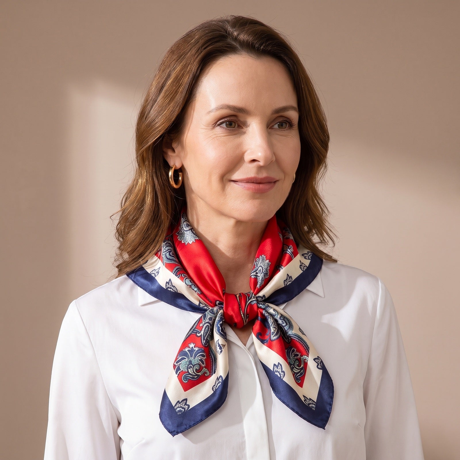 A woman wearing the Red Floral Silk Satin Square Scarf 90x90cm knotted at the neck over a white shirt